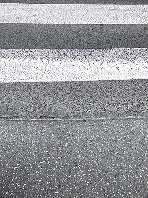 No kerb on footway leaving crossing island onto road with a marked crossing