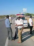 Traffic Sub-Inspector of Police with Interceptor using Black Berry phone for vehicle and driver records