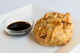 A dim sim with soy sauce